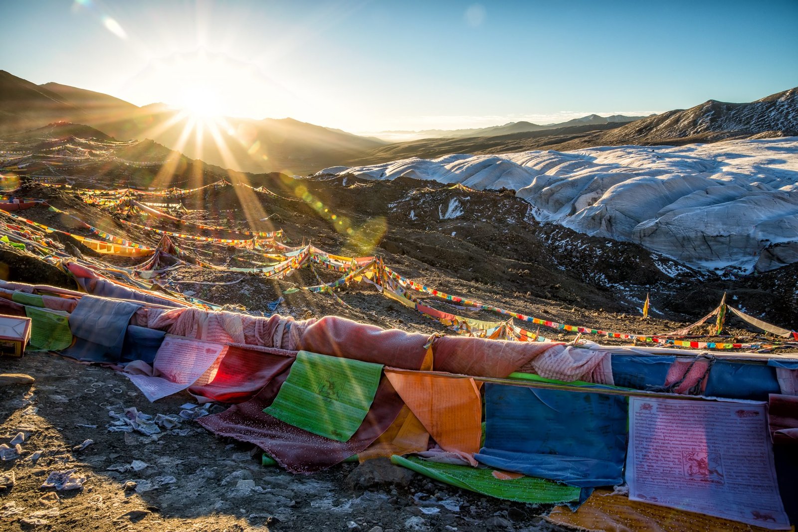 Assorted-color Flags on Mountain during Sunrise